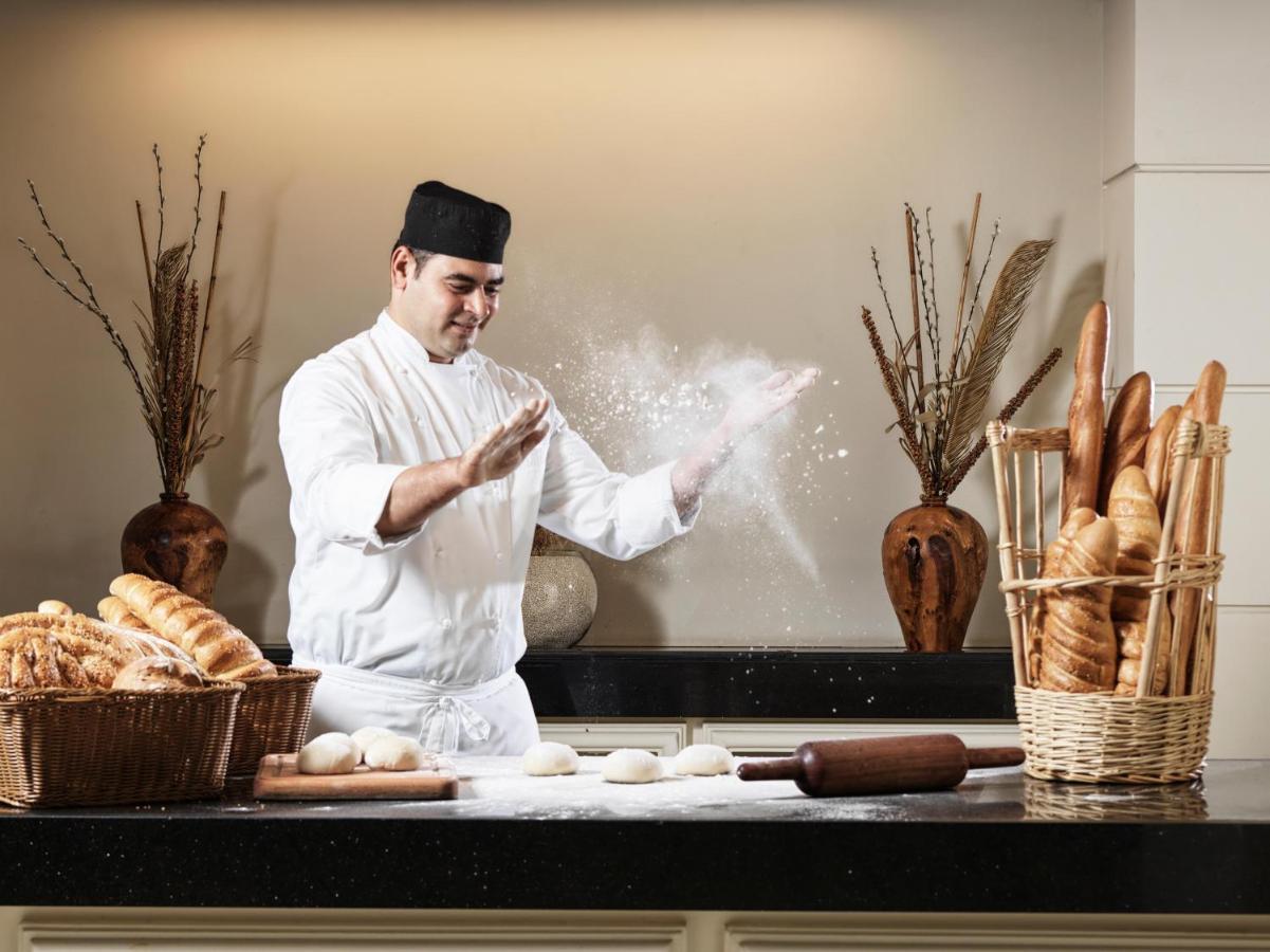 Fanar Hotel & Residences Salalah Exterior photo A baker preparing bread