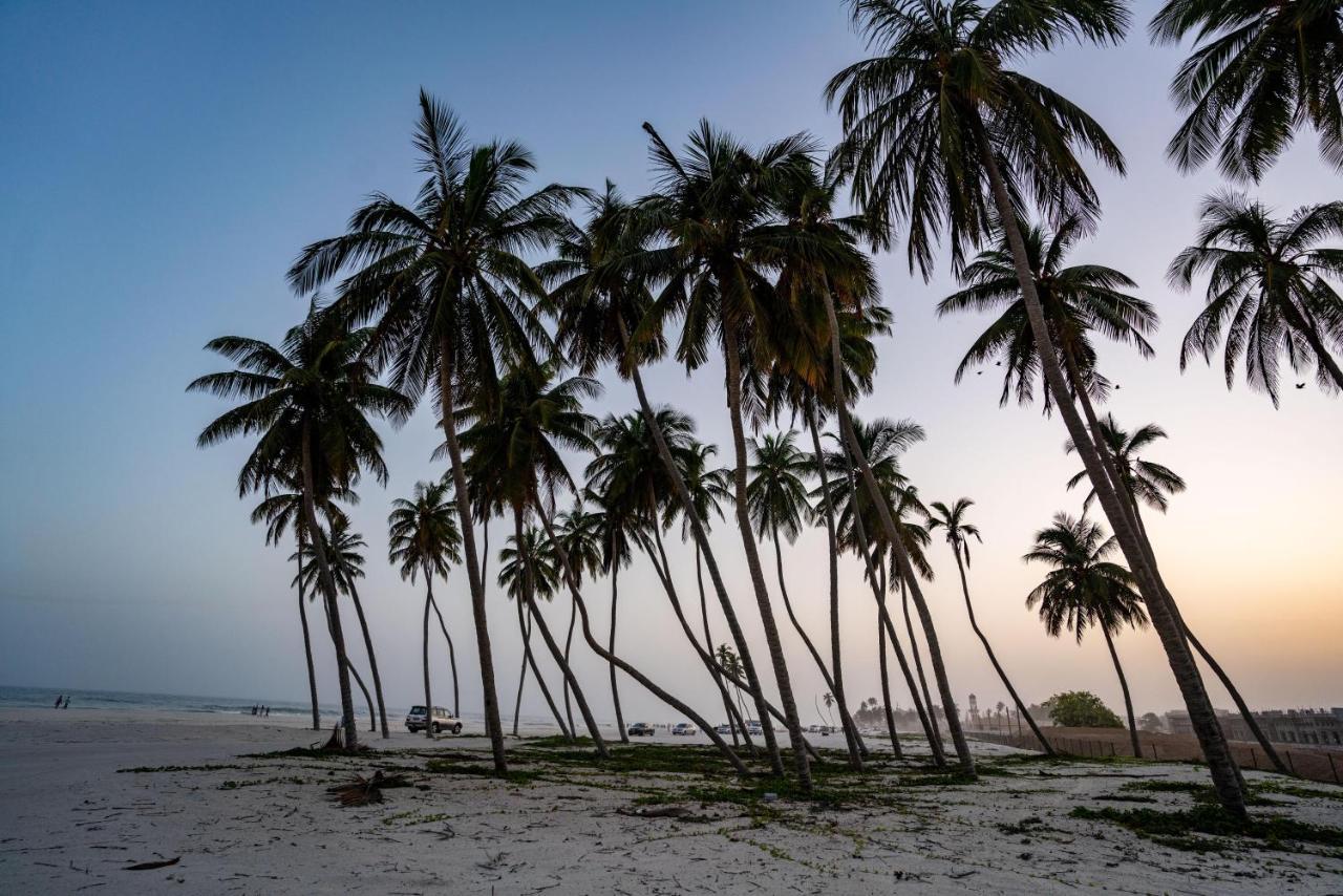 Fanar Hotel & Residences Salalah Exterior photo Palm trees on the beach of Awutu